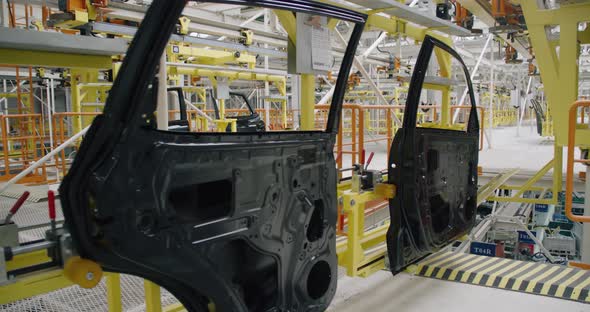Automobile Plant, Modern Production of Cars, Transportation of Ready Car Doors on the Production alt