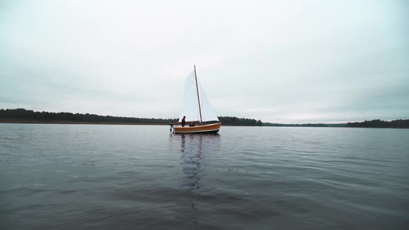 Master and Assistant Working at Sailboat on Water alt