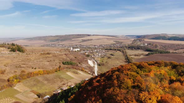 Drone Flight Over Fall Village. Autumn Leaves and Trees. Orange, Red, Yellow and Green Beautiful