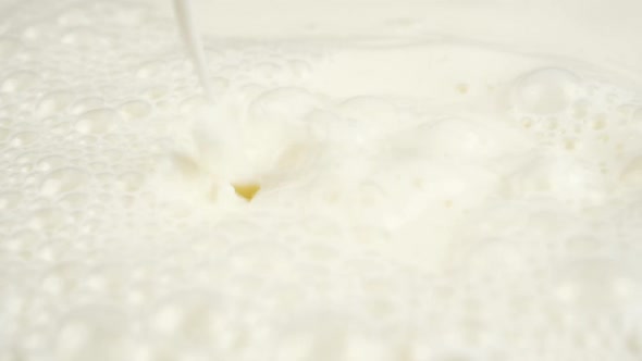 Pouring Milk closeup. Milk Splesh Slow Motion.