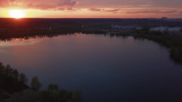 Colorful Sunset Over the Road with Cars Overlooking the Forest and Lake Ukraine Kiev on May 6 2021