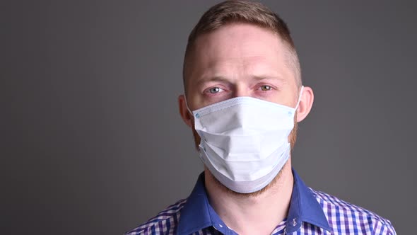 A man take-off medical mask from his face. epidemic swells, viruses. No longer scary, covid is over alt