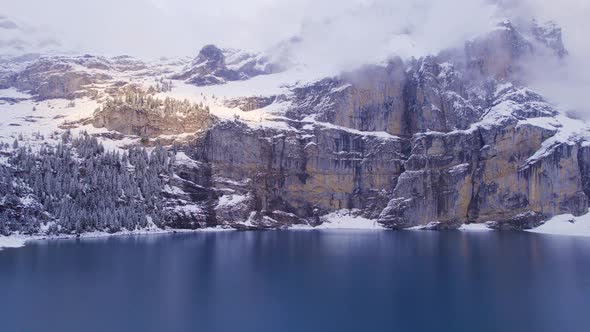 Oeschinen Lake in Switzerland Surrounded by Snow Covered Forests and Mountains alt