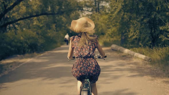 Hair Blowing On Wind. Beautiful Cyclist Girl Hair Blowing When Riding Bicycle. Hair Flying On Wind. alt