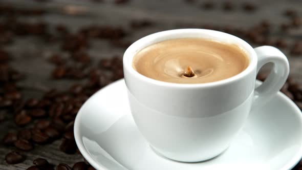 Drop Falling Into a Cup of Coffee in Super Slowmotion. alt