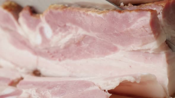 Cured bacon tasty food cutting shallow DOF  4K 2160p 30fps UltraHD   footage -  Woman use knife for  alt