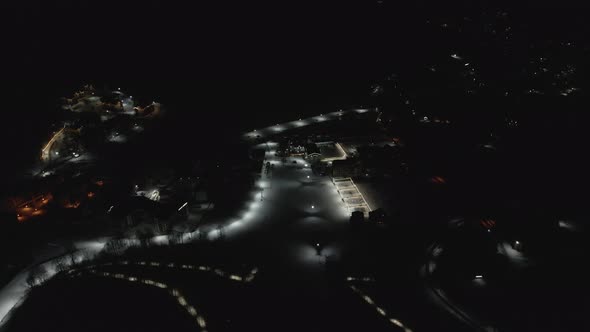 Flying at night over rope-way with gondolas at mountain resort Crystal Park in Bakuriani.  alt