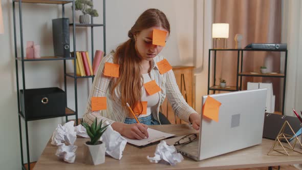 Exhausted Woman Freelancer with Pasted Stickers Using Laptop Having Concentration Problem in Office alt