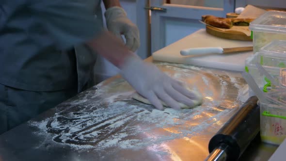 Male Cooker with Gloves is Kneading Dough alt