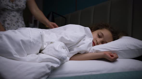 Child Little Baby Girl Sleeps Sweetly in His Crib and Smiles in His Sleep alt