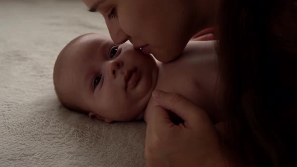 Authentic Close Up Shot Young Neo Mother Mum is Playing with Nake Newborn Child Baby on White Soft alt