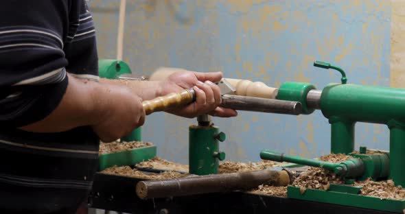 Carpenter turning wood on a lathe alt