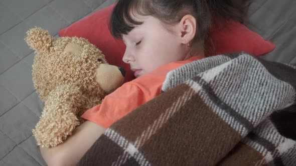 Relaxing in bed with teddy bear.  alt