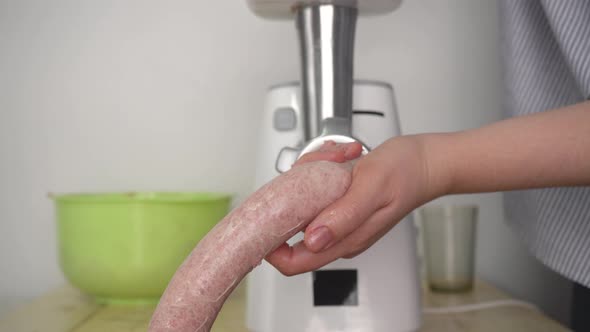 Girl makes homemade barbecue sausage, sausages for frying