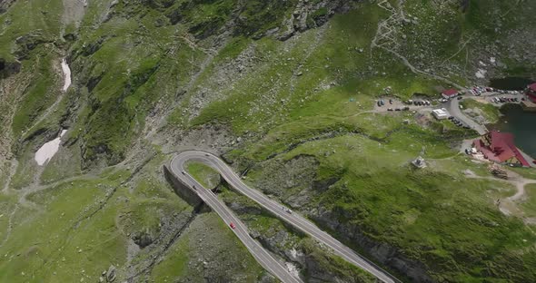 aerial view of part of winding transfagarasan road with moving cars alt
