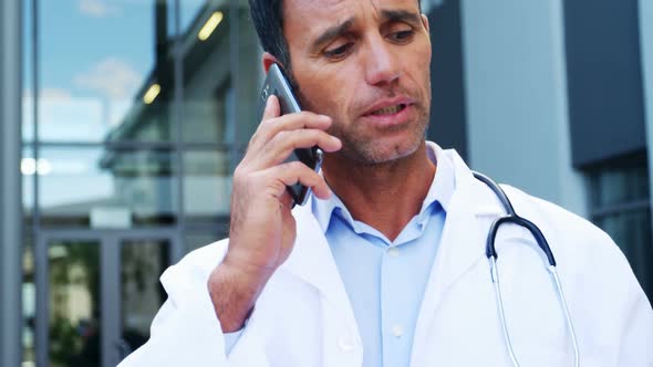 Doctor talking on mobile phone alt