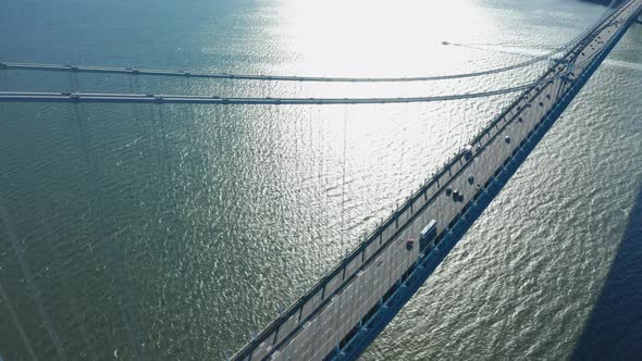 Aerial Drone Shot Descending From Top of Verrazano Bridge Toward Road Deck in NY alt