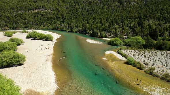 People fly fishing in Lake Cholila, Patagonia, Argentina, aerial forward flyover wide shot alt