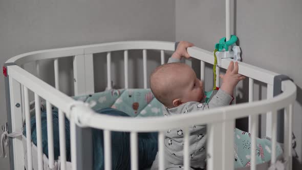 Baby Standing in a Crib at Home