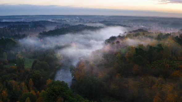 Foggy river and forest in autumn, view from above alt