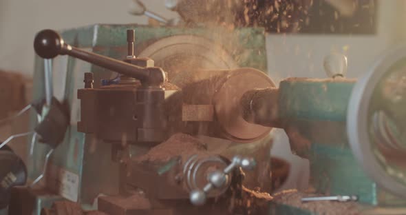 Man working on a wood lathe creating art - slow motion macro shot alt