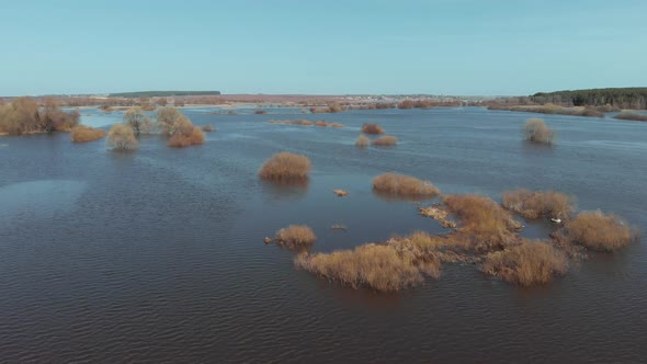 On a Sunny Spring Day the Camera Flies Fast Over a Flooded Area of the Field alt