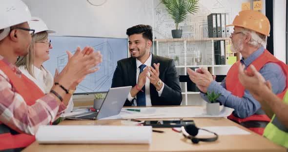 Male and Female Team of Construction Specialists Applauding Sucessful Done Architectural Project alt