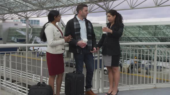 Group of business people meeting and talking at airport