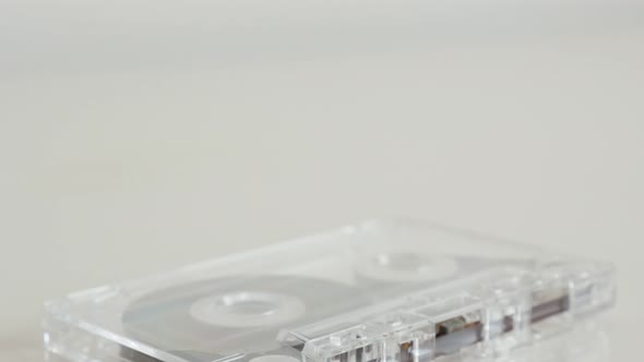 Tilting over analogue  magnetic audio tape on white 4K 2160p 30fps UltraHD footage - Close-up of ret alt