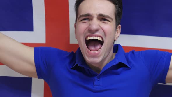 Icelandic Young Man Celebrates Holding the Flag of Iceland alt