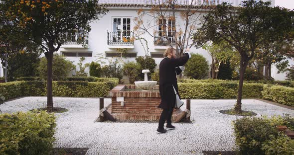 Man Performing Martial Arts In Formal Garden alt