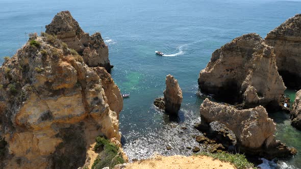 Ponta de Piedade, Portugal, Boat Sailing Between Scenic Limestone Rock Formations on Sunny Summer Da alt