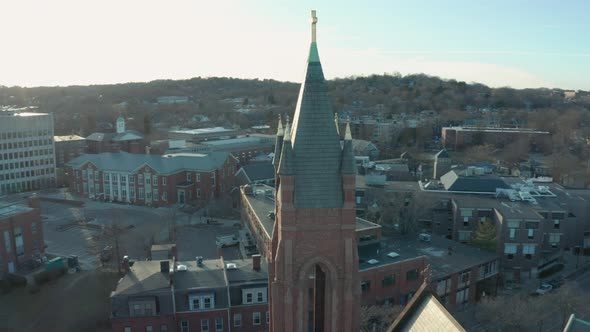 Aerial Drone Shot Orbiting a Brick Church Steeple in Suburban Boston alt