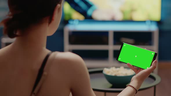 Person Holding Modern Phone with Horizontal Green Screen alt