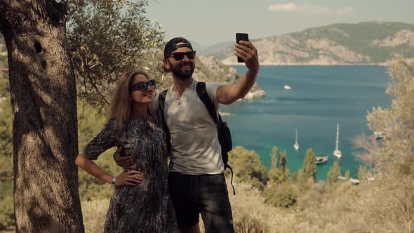Boy And Girl On Holidays Romantic Vacation. Selfie Couple On Beautiful Place On Cellphone. alt