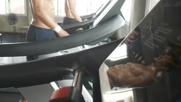 strong sportsman with trainer working out on bike at gym, Friends in a conversation alt