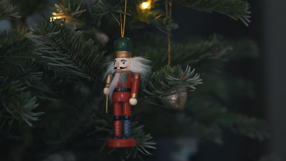 Nutcracker Soldier Toy on a Christmas Tree With Blurred Background Dolly 4K Shot. alt