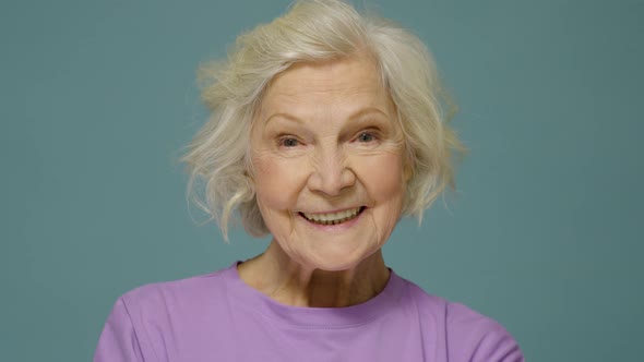 Portrait of attractive cheerful content wise woman isolated over vivid blue color background alt