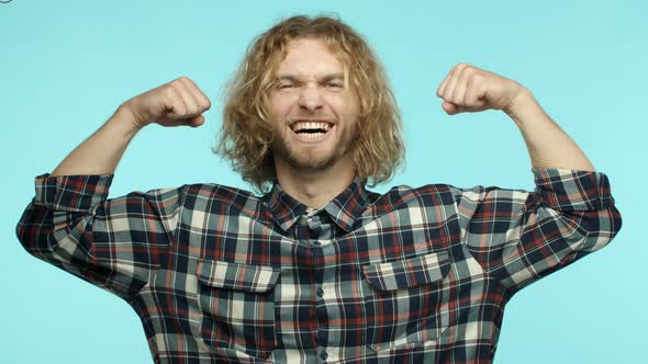 Slow Motion of Handsome Blond Man with Wavy Long Hair and Beard Feeling Healthy and Strong Flexing