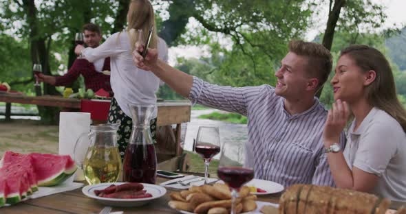 Young Happy Couple Taking Selfie While Having Picnic French Dinner Party Outdoor During Summer alt
