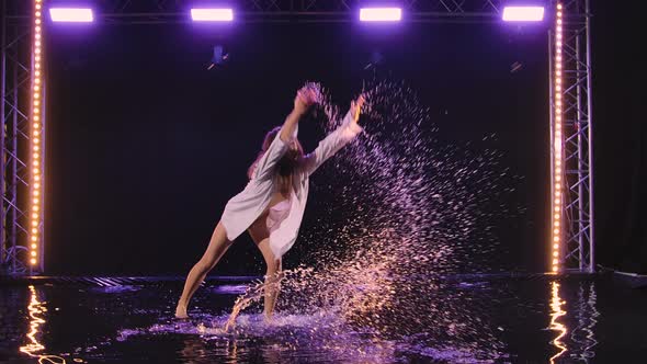 Woman in White Shirt and Beige Bodysuit is Dancing Dramatic Dances of Modern Ballet in Rain alt