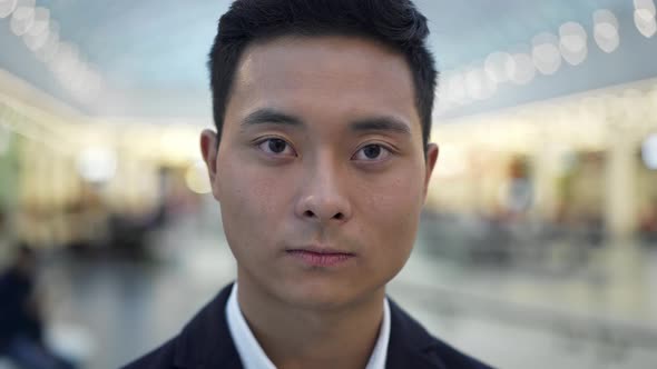 Close Up Portrait of Asian Male Seriously Looking Straight at Camera