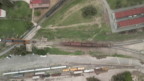 Cenital view of train arriving to train station alt