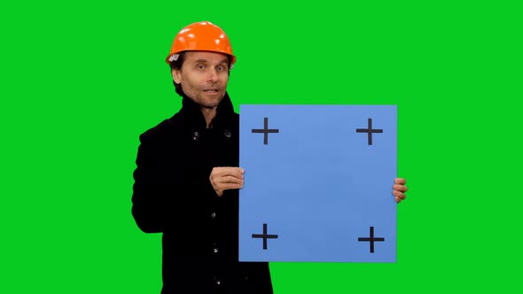 Constructor Builder in Hardhat Telling the Workplan with Blue Blank Billboard on Green Screen 