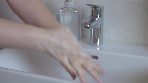 Washing Hands with Soap Under Faucet with Water
