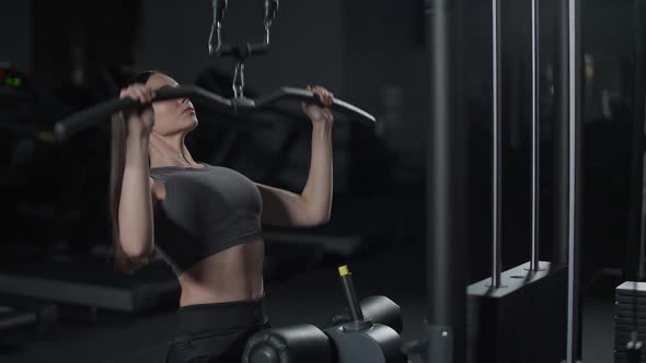 Female in the Gym Lifting Blocks on Rack Machine Strength Training on Block Device and Gym Equipment alt