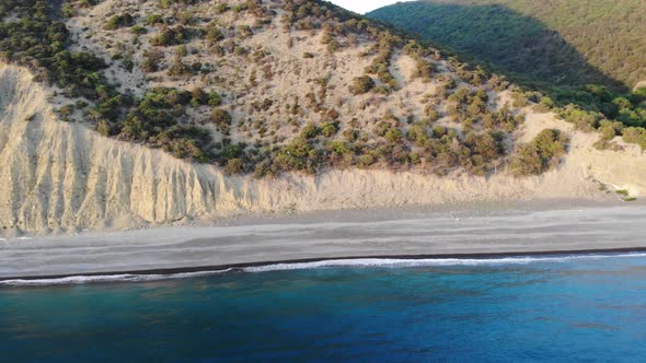 Aerial Flight with Drone DJI Over Beautiful Green Mountains and White Sandy Beach.  alt