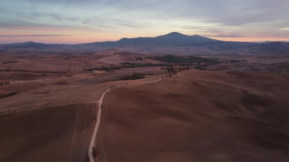 Val d'Orcia Cypress Trees Road and Farmhouse in Tuscany Aerial View alt