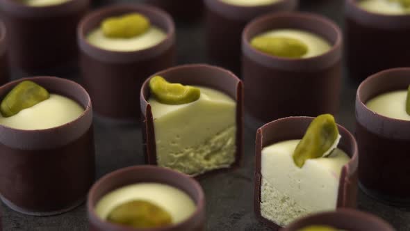 Camera Movement of Chocolate Candies with Creamy Filling Cream and Pistachio Nuts
