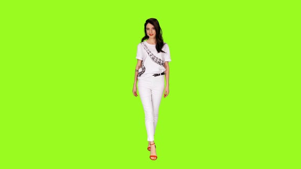Young Glamour Brunette Woman in White Clothes Walking on Green Background